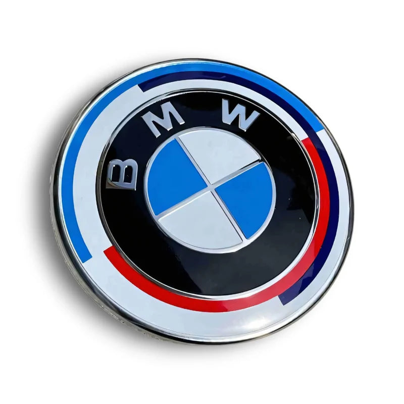 BMW M 50th Anniversary emblem set with hood badge, trunk badge, steering wheel emblem and wheel center caps installed on BMW vehicle