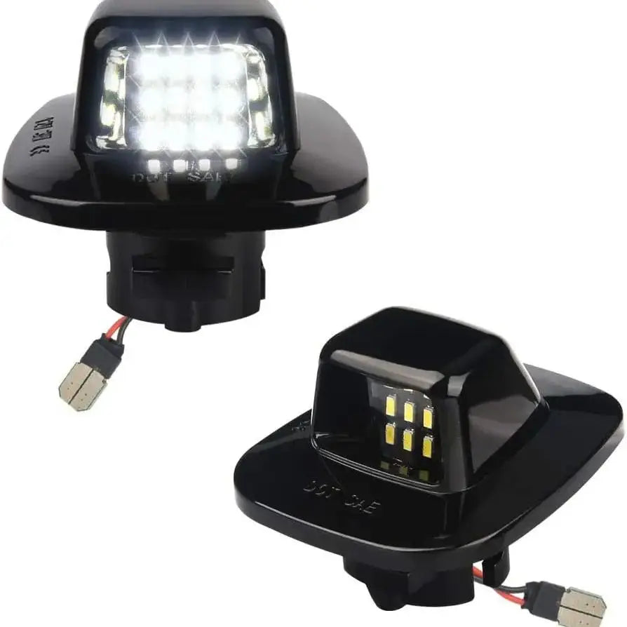 6000K white LED license plate light assemblies for Chevy Silverado, GMC Sierra, Tahoe, Yukon and compatible trucks and SUVs.