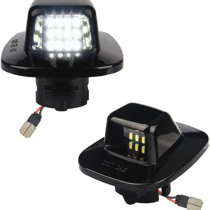 6000K white LED license plate light assemblies for Chevy Silverado, GMC Sierra, Tahoe, Yukon and compatible trucks and SUVs.