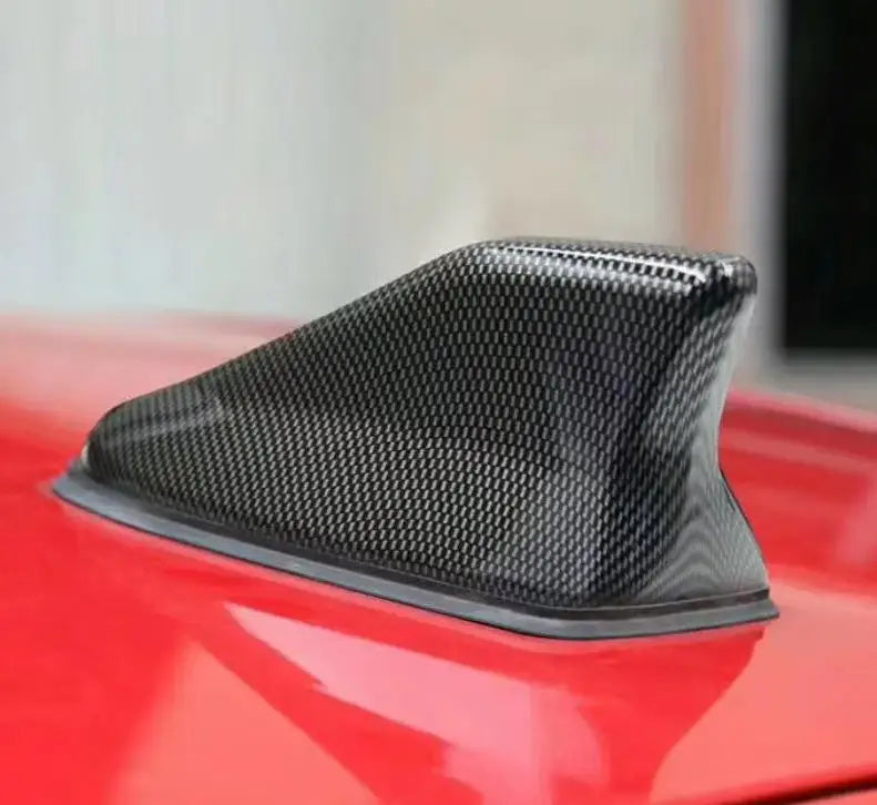 Universal SharkBoost shark fin antenna installed on a modern vehicle with sporty premium design.